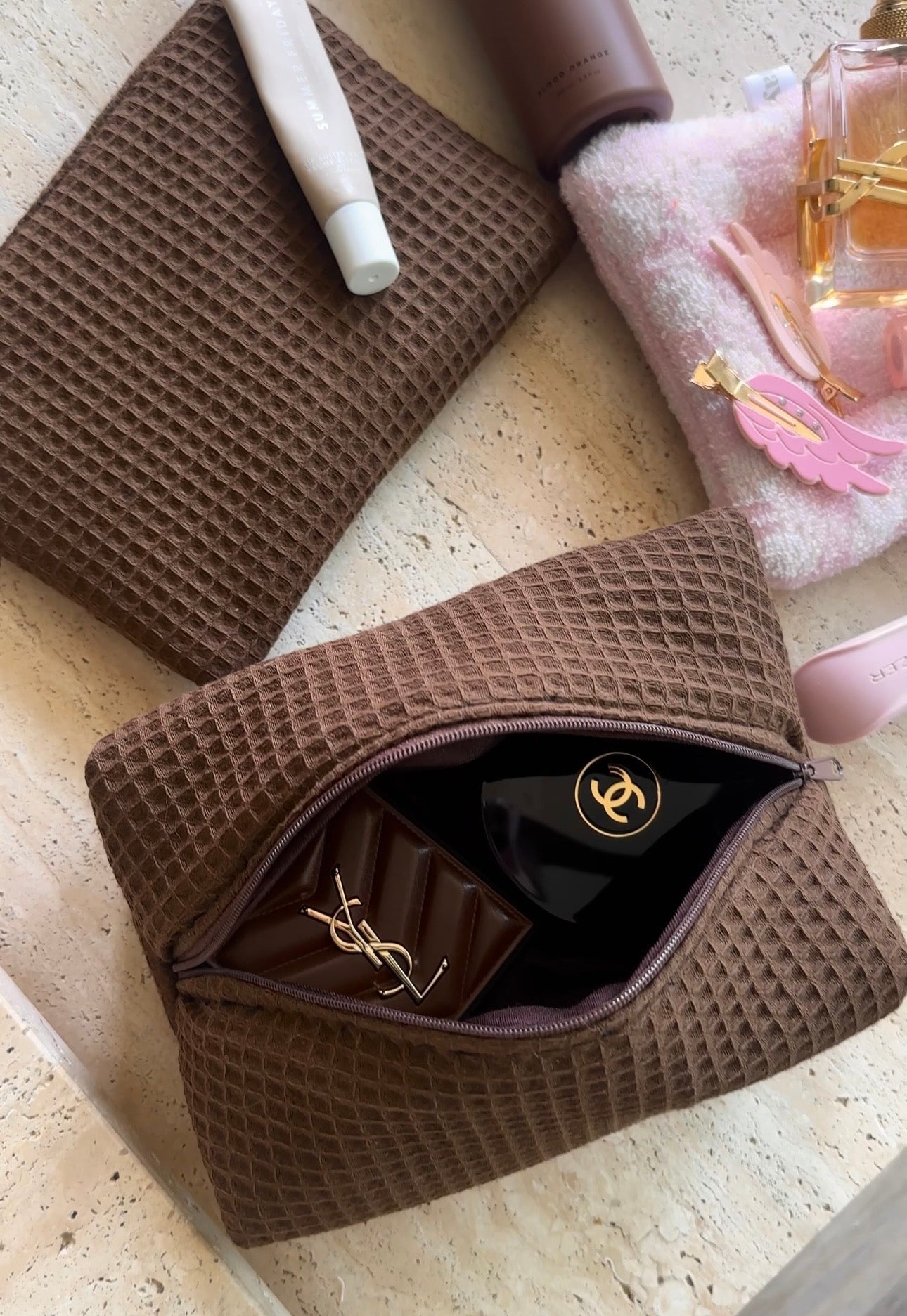 Espresso brown waffle knit zip pouch, open with black lining and gold zipper pull