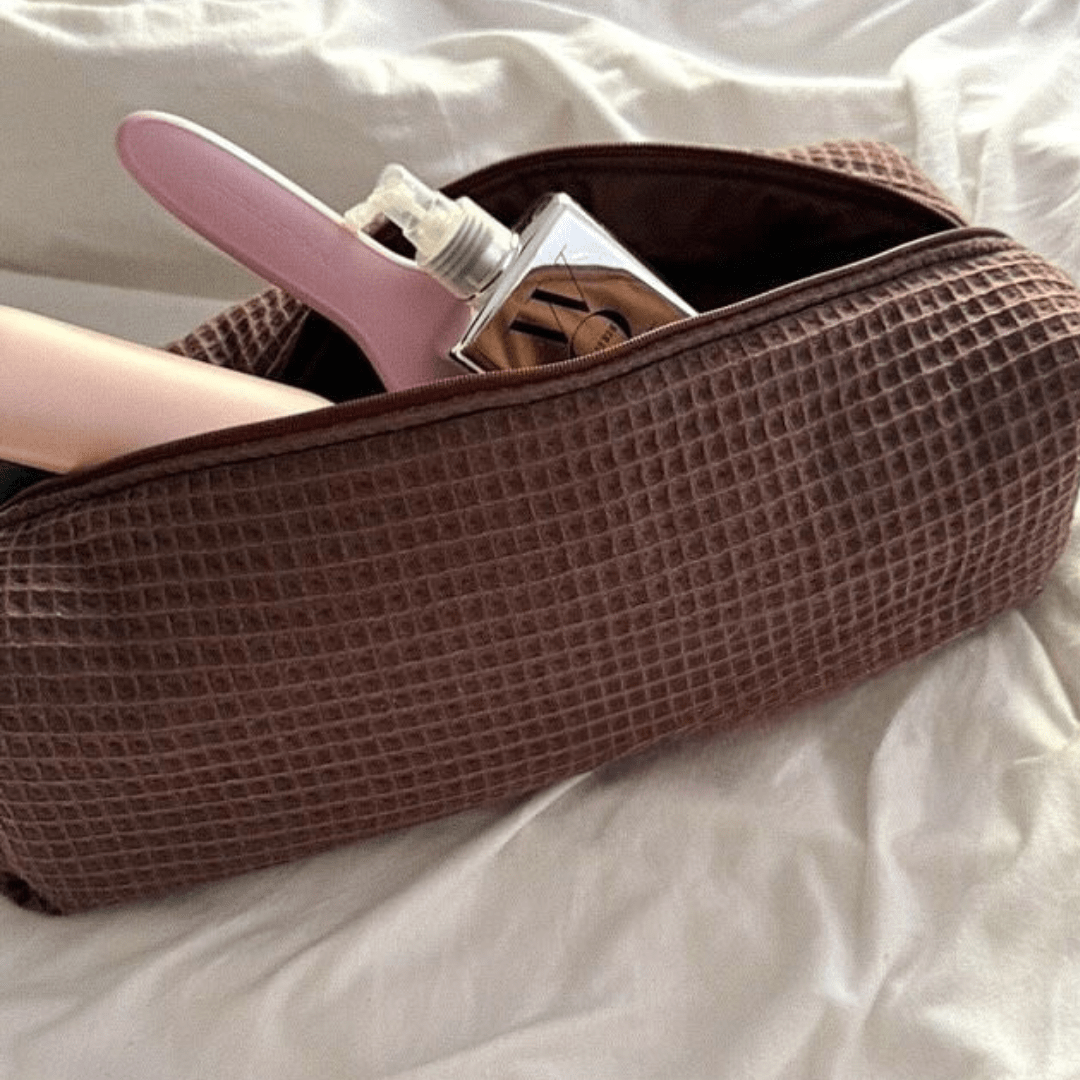 Espresso brown waffle knit long pouch with zipper, opened to dark interior