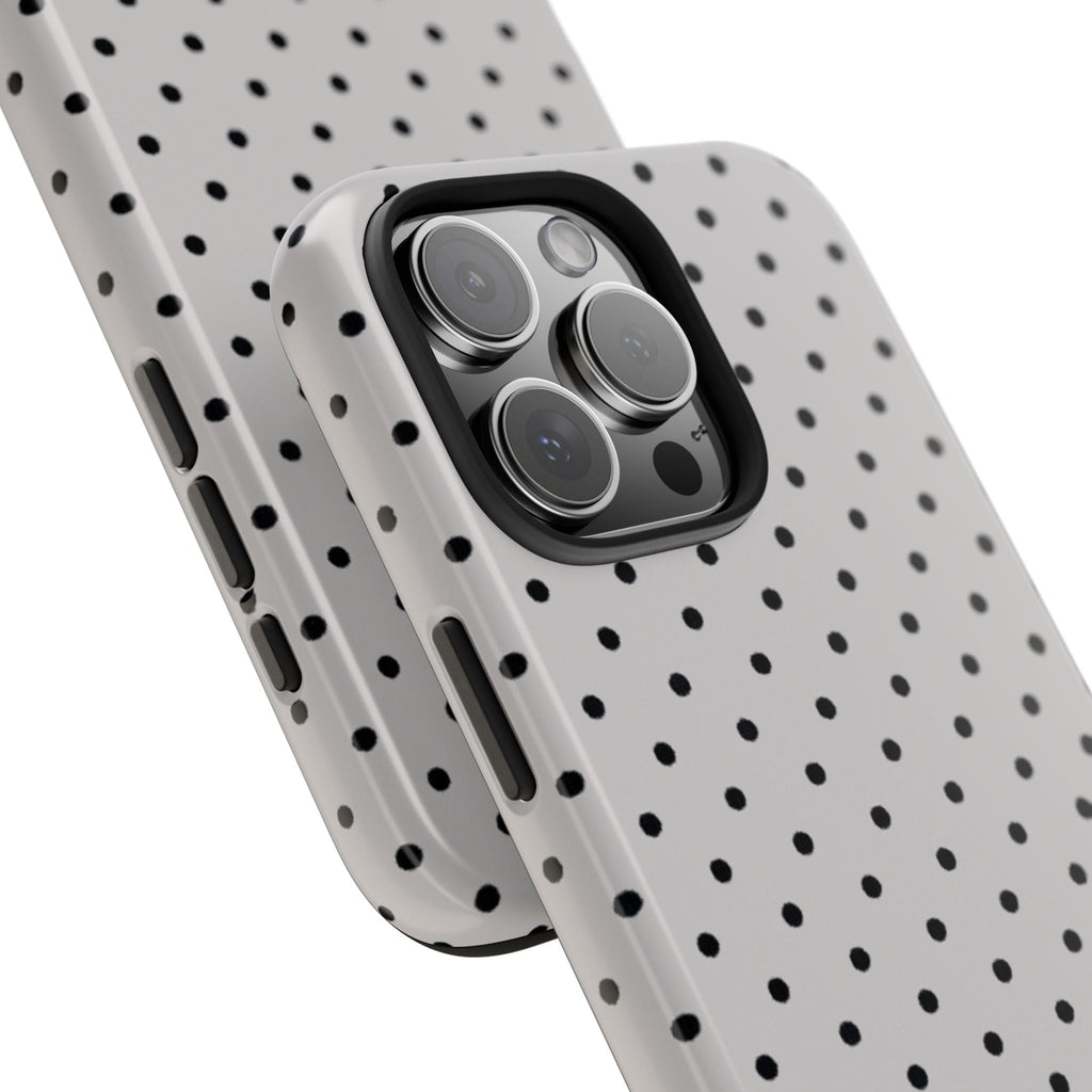 Angled view of gray polka dot phone case with camera lens cutout and grip rails