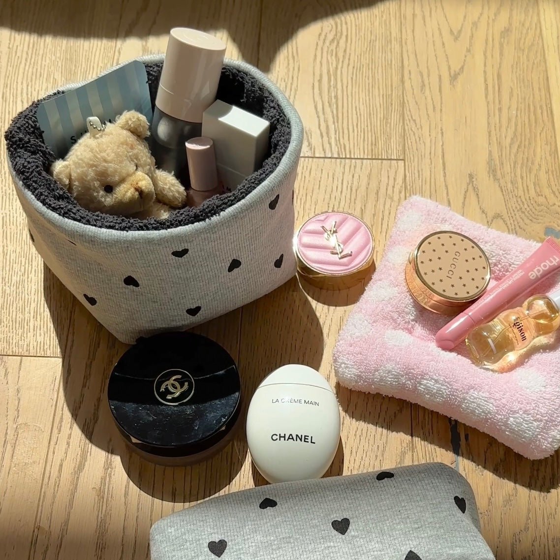 Gray fabric organizer basket with small black heart pattern, open top