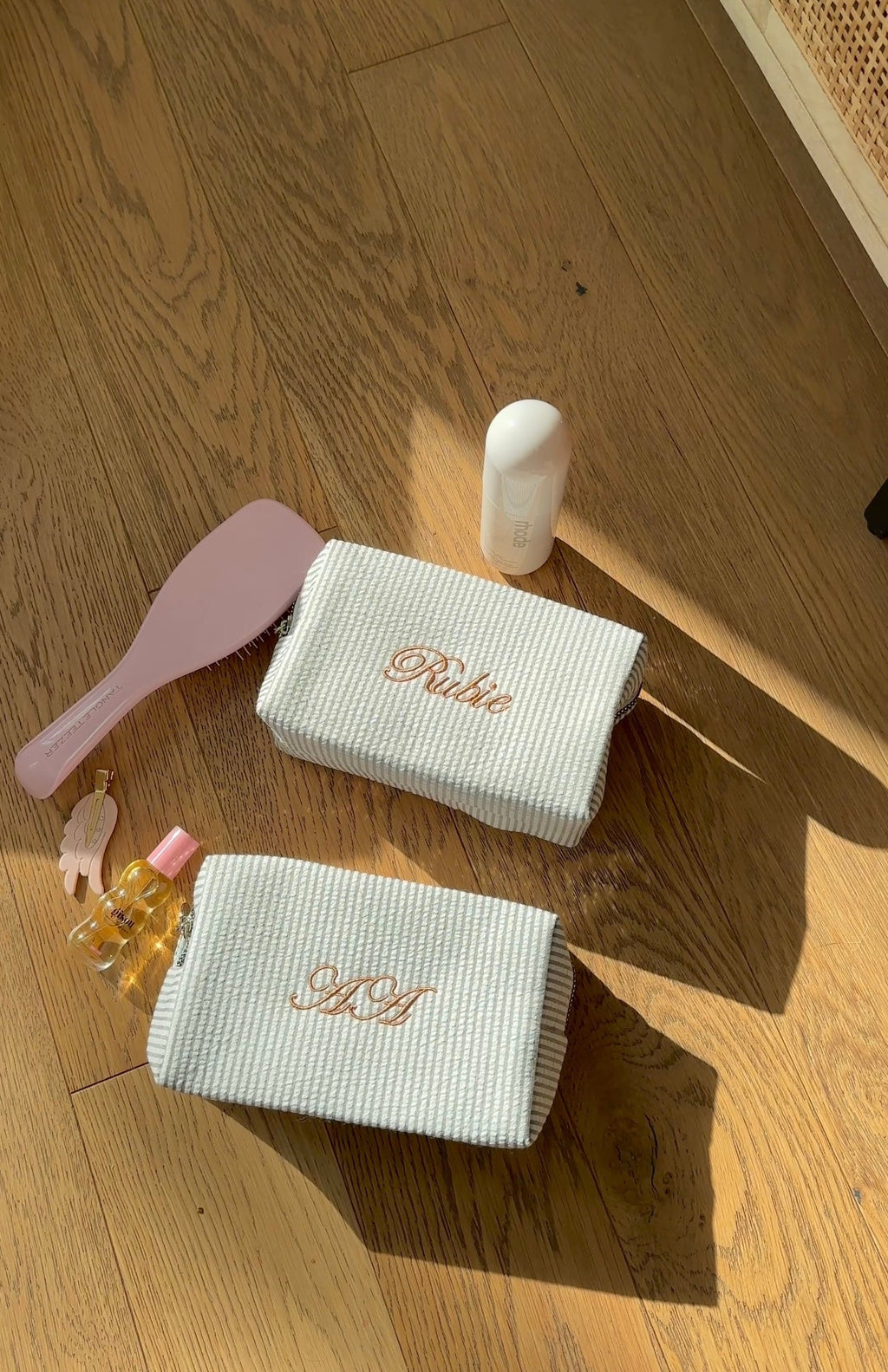 Light gray striped custom embroidery bag with cursive monogram on flap