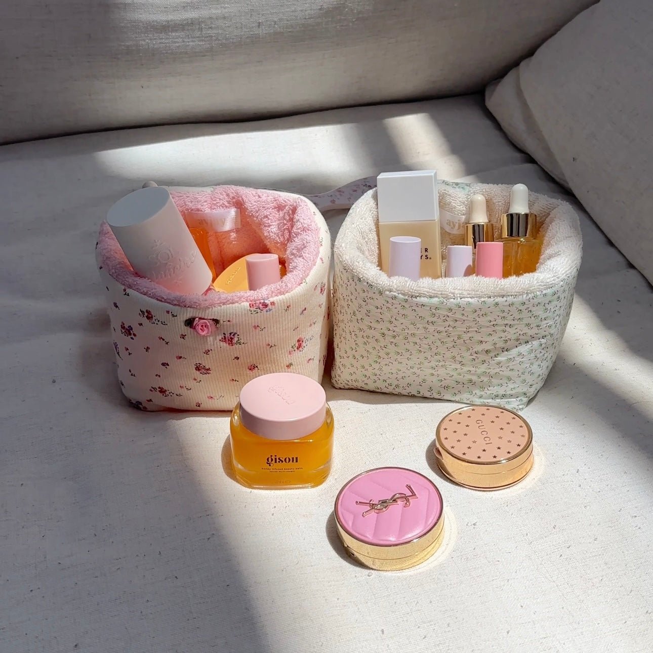 Green ditsy floral organizer (right), open round bin with toiletries set inside