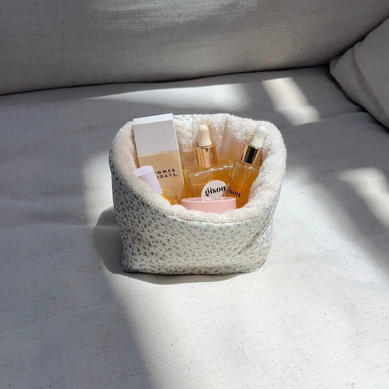 Green ditsy floral fabric organizer, round bin with open top and plush lining