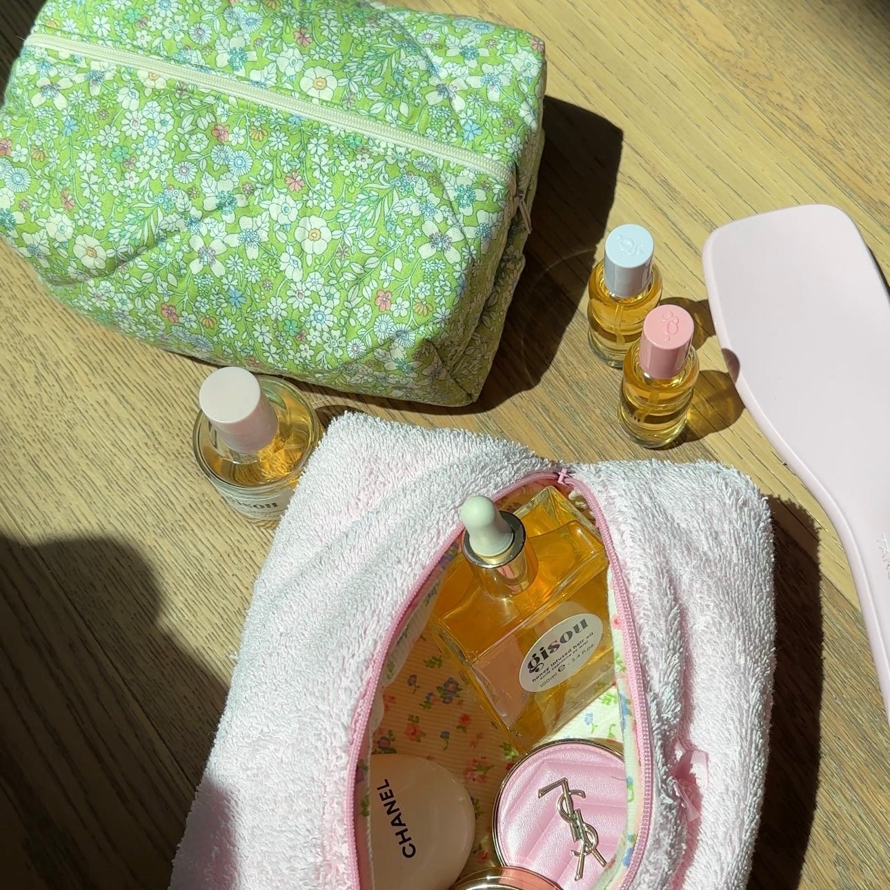 Open green floral zip pouch, interior fabric and zipper track visible