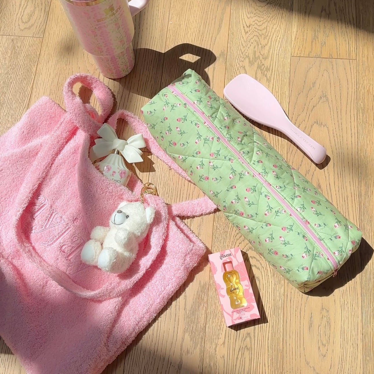 Mint green rose floral toiletry pouch with pink zipper, angled view