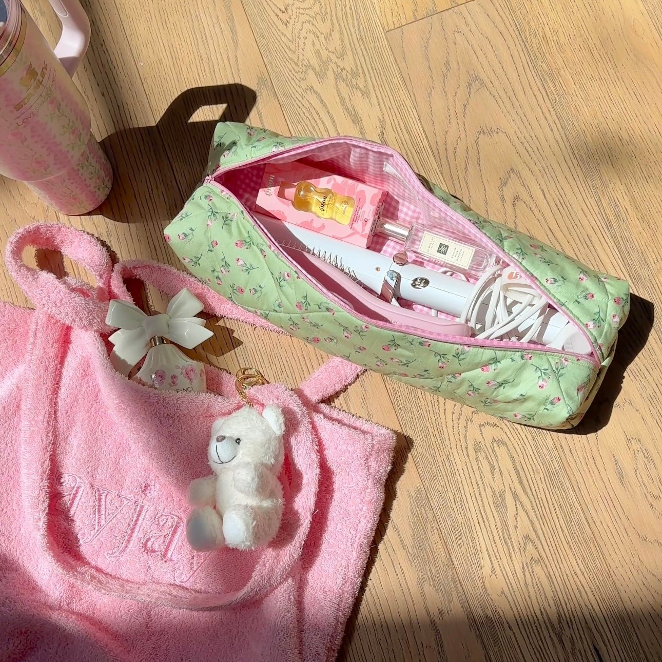 Mint green rose floral toiletry pouch with pink trim, pink zip open