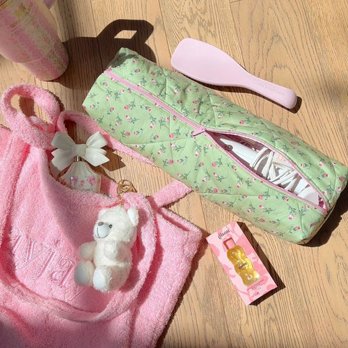 Mint green rose floral toiletry pouch, pink zip open to reveal bottles