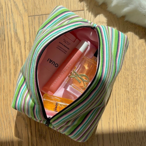 Green striped zippered pouch, open top showing interior lining and divider