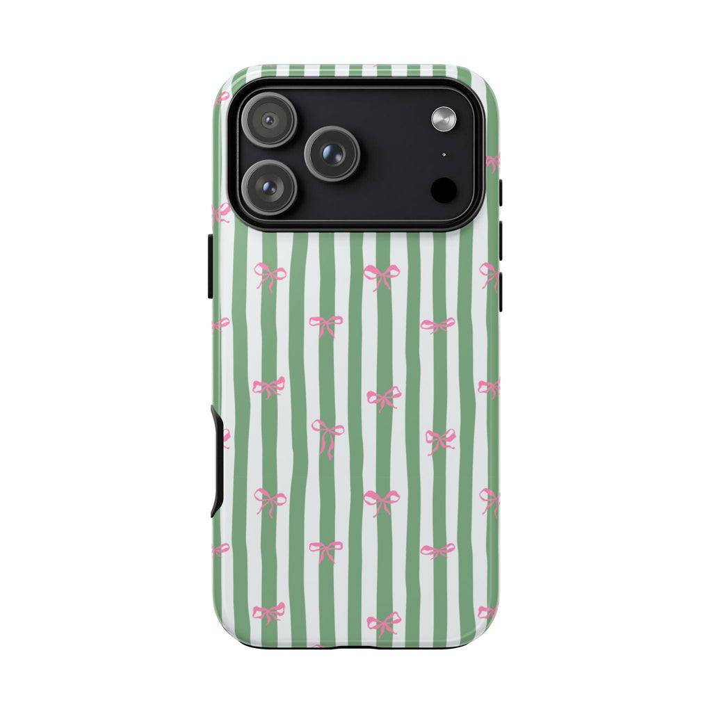 Phone case with green-and-white vertical stripes and pink bow pattern; raised camera cover