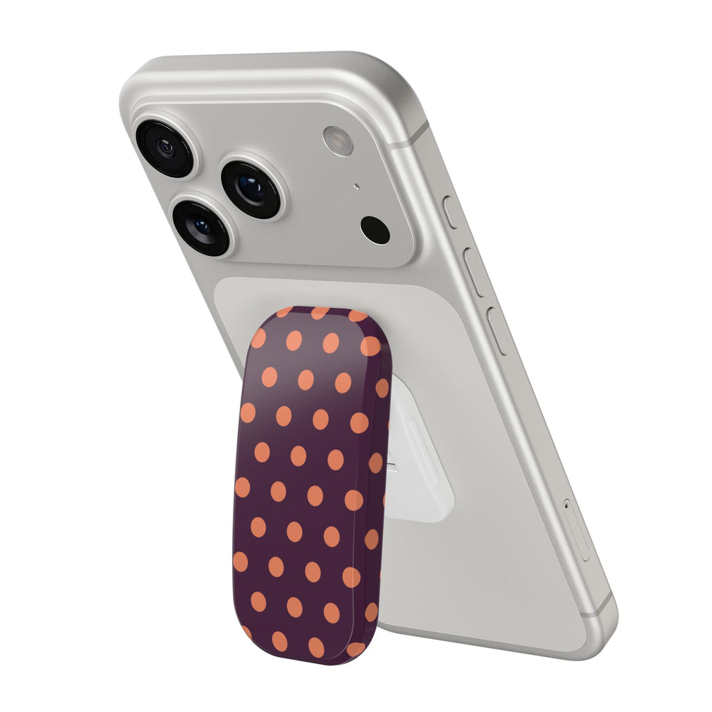 Aubergine polka dot phone grip on a light gray phone case