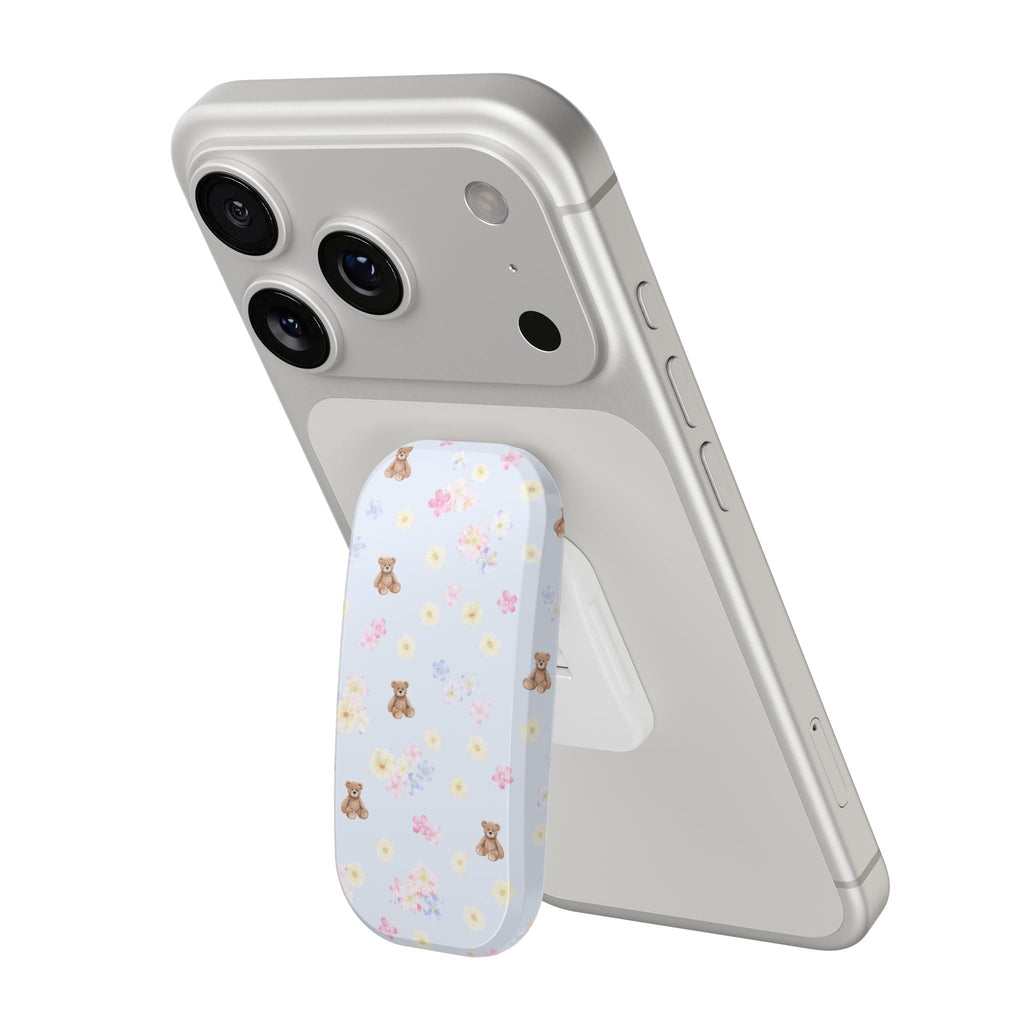Bear and floral phone grip attached to a phone case, rounded edge