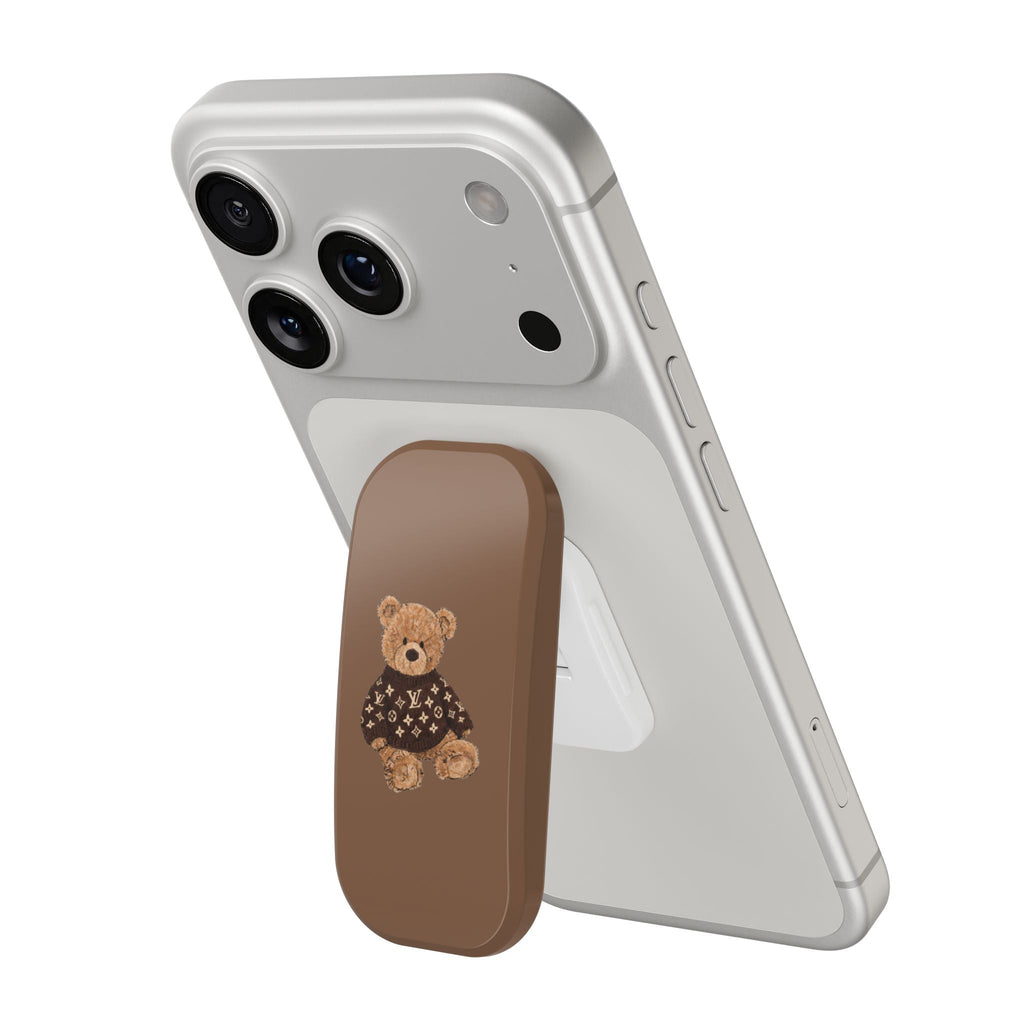 Gray phone case with brown grip and teddy bear patch wearing dark monogram sweater
