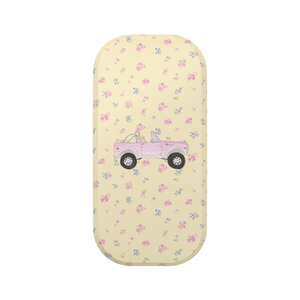 Rounded phone case with pastel floral pattern and pink truck graphic on light yellow base
