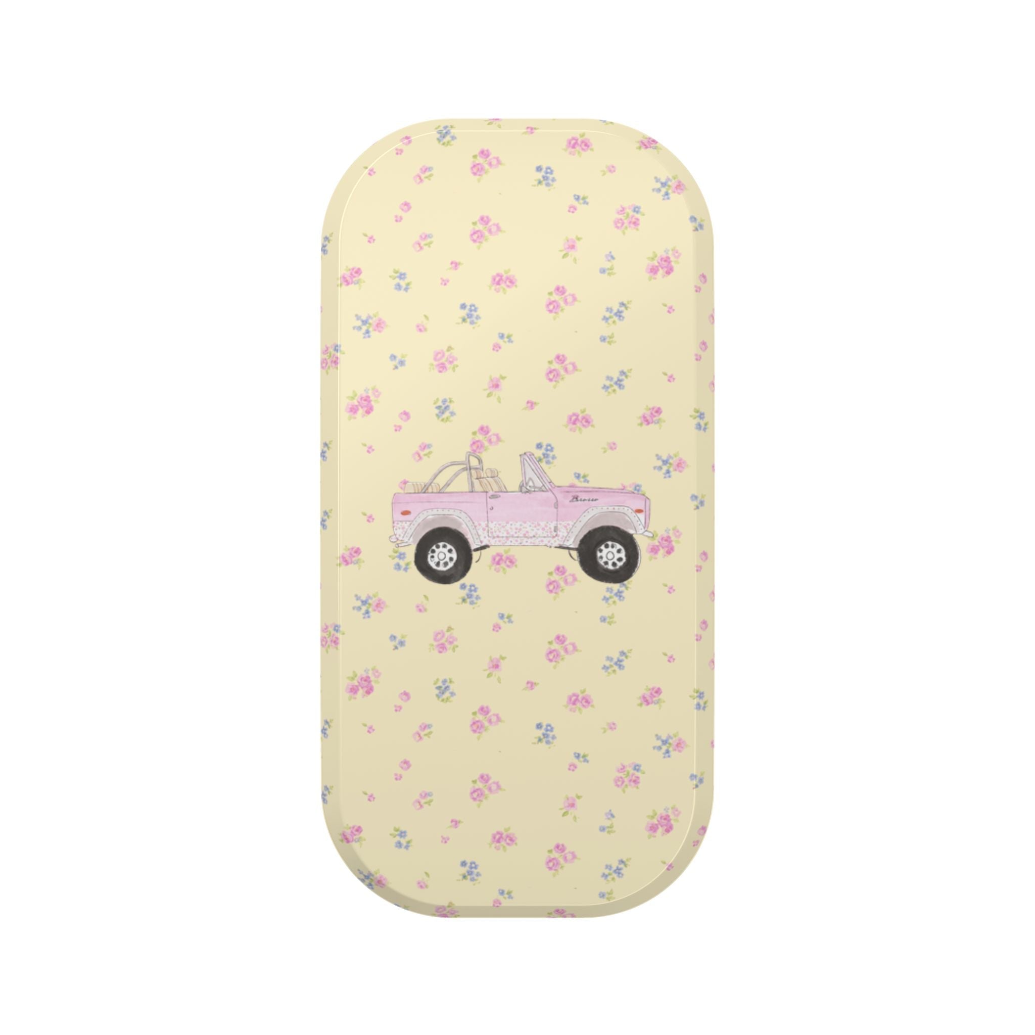 Rounded phone case with pastel floral pattern and pink truck graphic on light yellow base