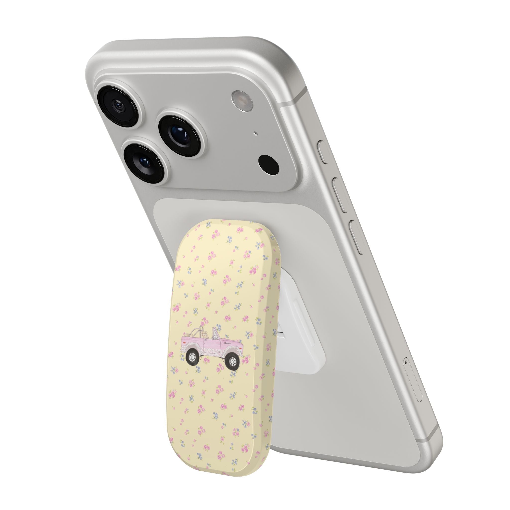 Light gray phone case with dual camera cutouts and cream floral grip pad with pink truck