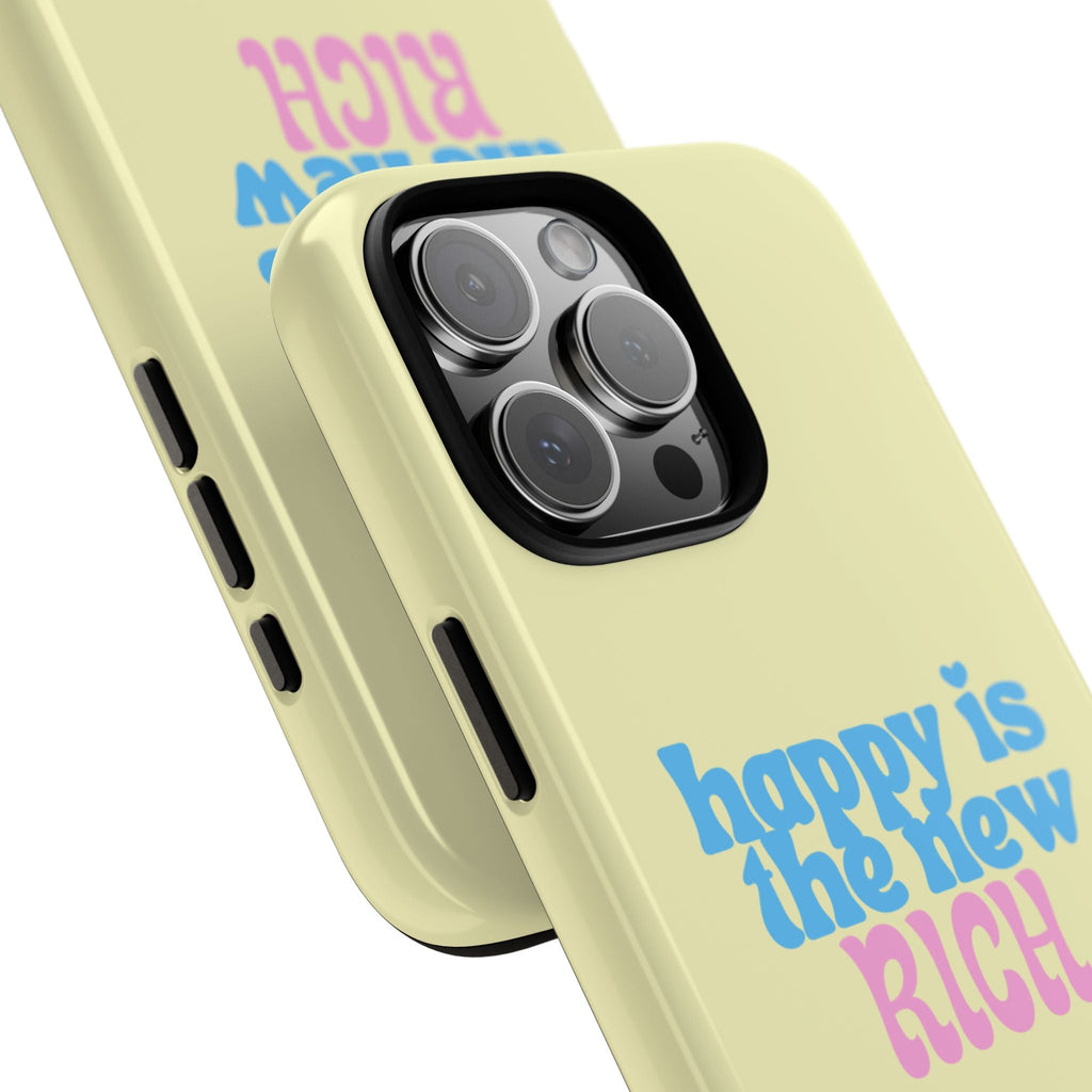 Pale yellow case angled view with camera cutout and 'HAPPY IS THE NEW RICH' text