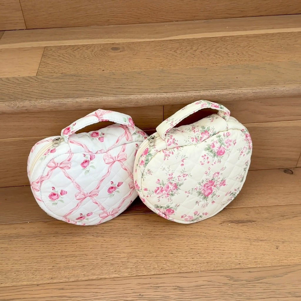 Two pink floral heart quilted bags with ribbon bow straps