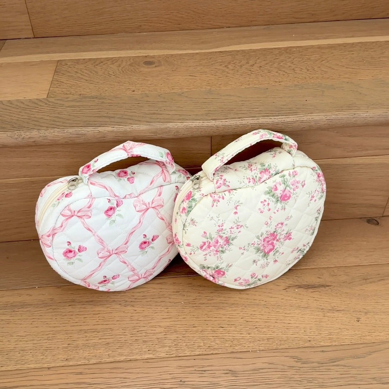 Two pink floral heart quilted bags with ribbon bow straps