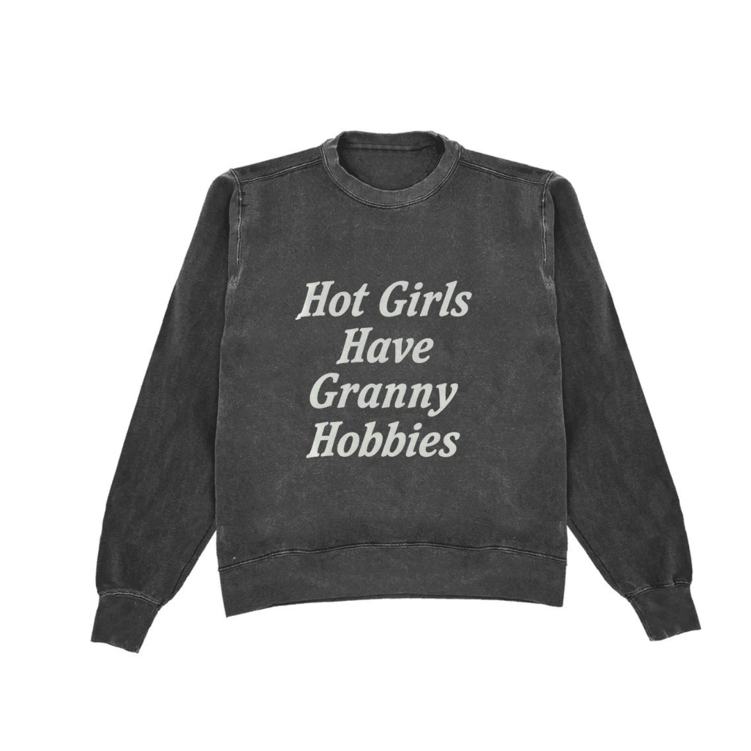Dark charcoal crewneck sweatshirt, 'Hot Girls Have Granny Hobbies' front text graphic