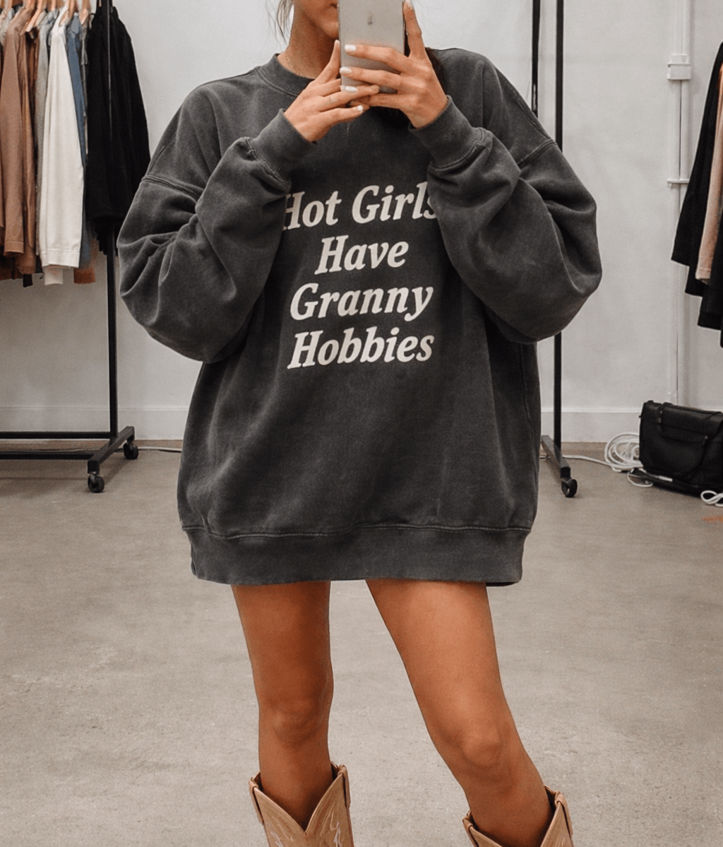 Dark gray crewneck sweatshirt with long sleeves and 'Hot Girls Have Granny Hobbies' graphic