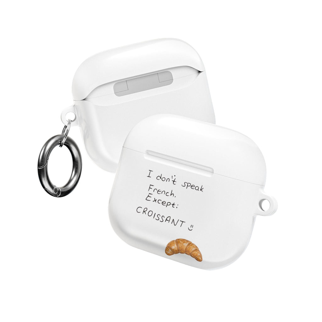 White AirPods case with key ring; “I don’t speak French” text and croissant emblem