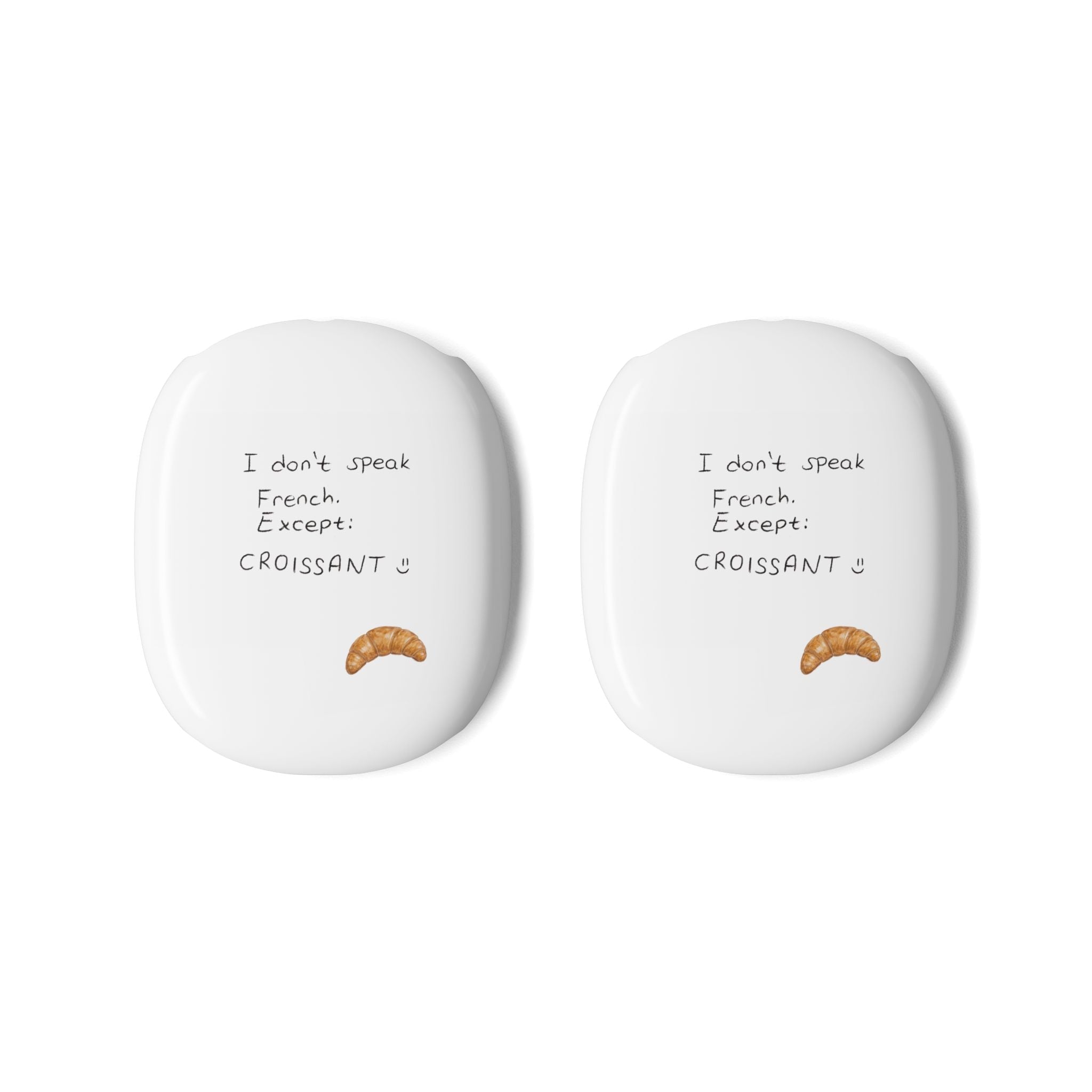 Two white ear cup covers for AirPods Max, croissant icon and French text