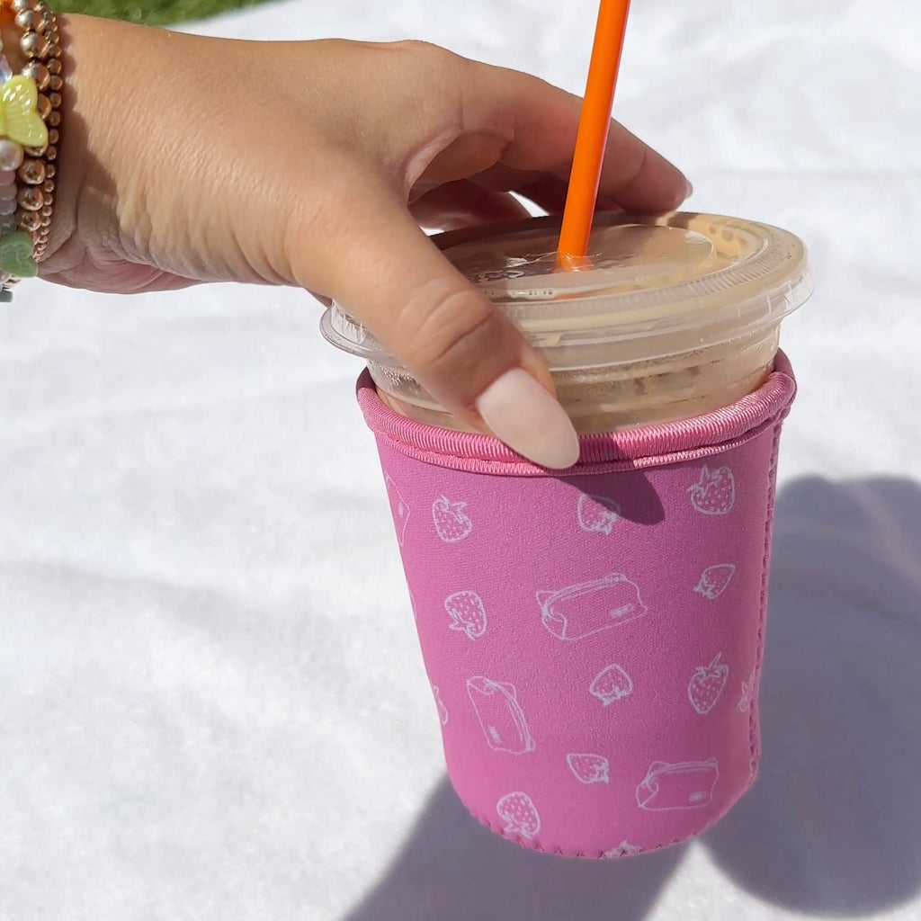 Iced coffee coozie, dark pink with all-over strawberry and drink icon pattern