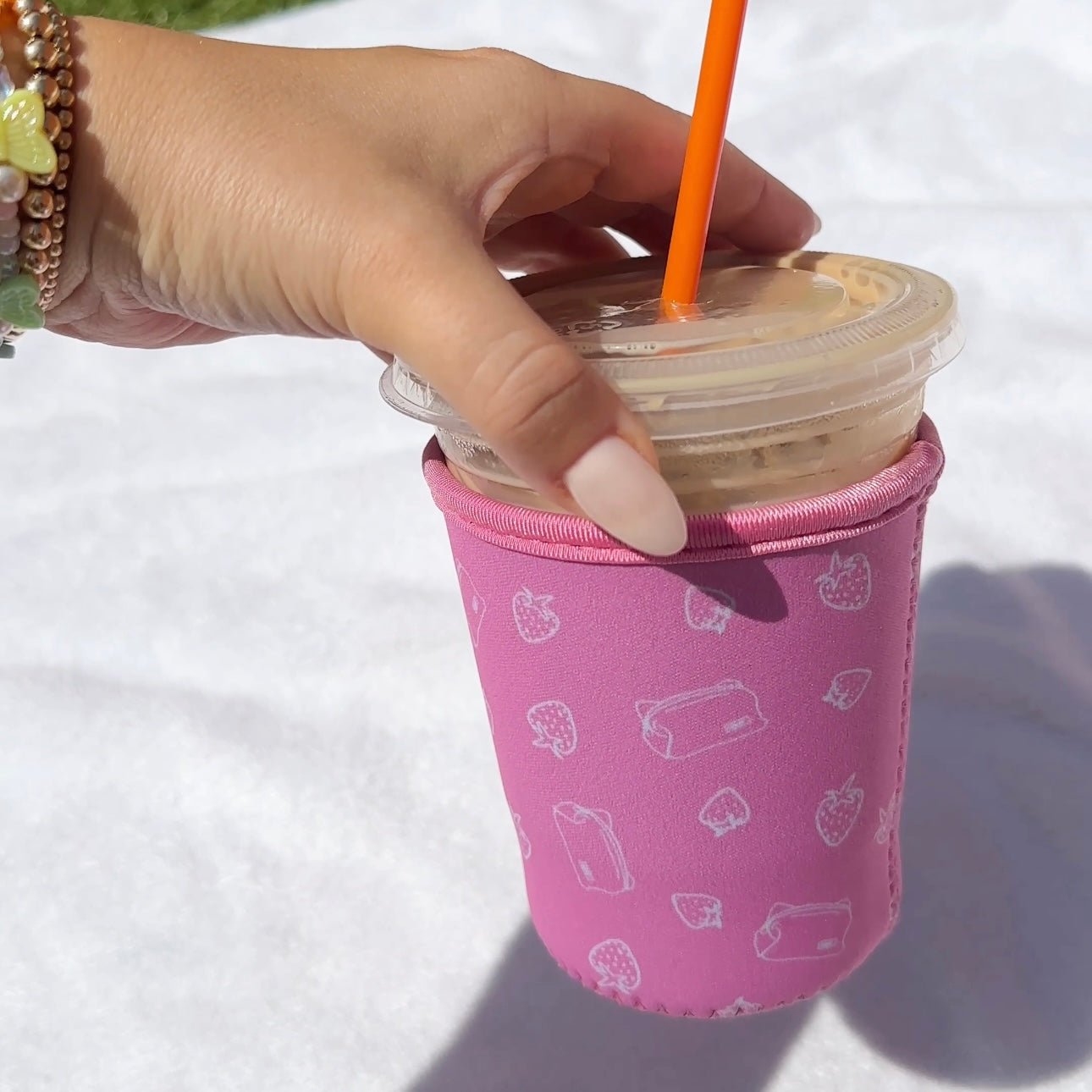 Iced coffee coozie, dark pink with all-over strawberry and drink icon pattern