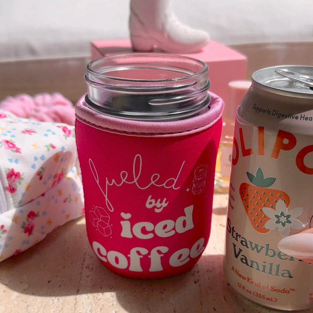 Close-up of pink “iced coffee” coozie with “iced coffee” logo and stitched rim