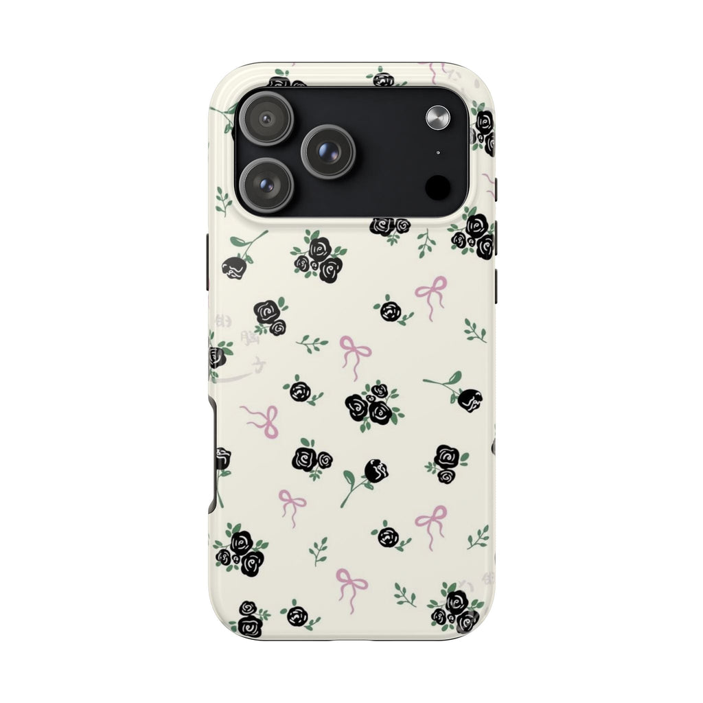 Ivory phone case with black roses, green leaves, and pink ribbon bows; camera area