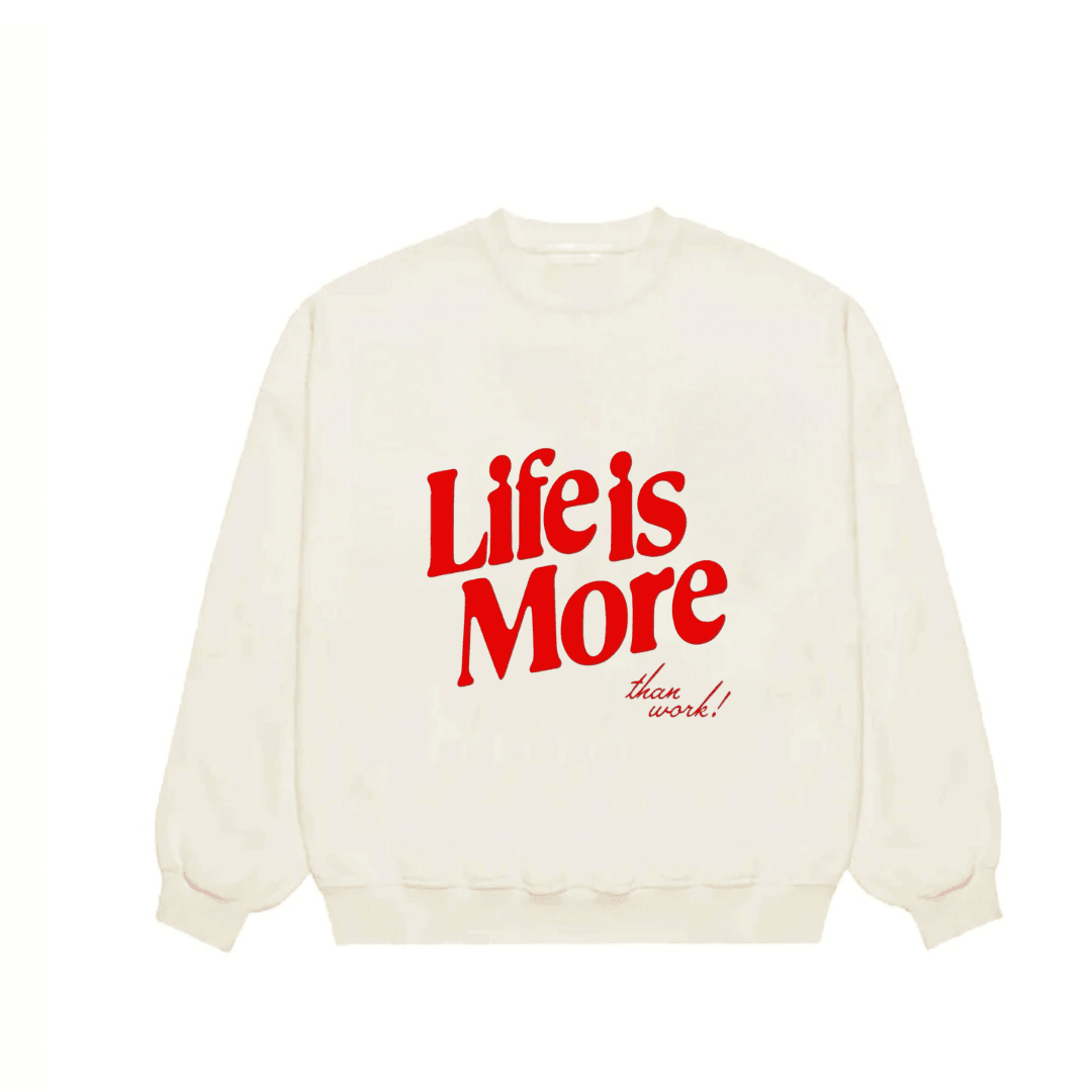 Ivory crewneck sweatshirt with red graphic text “Life Is More”