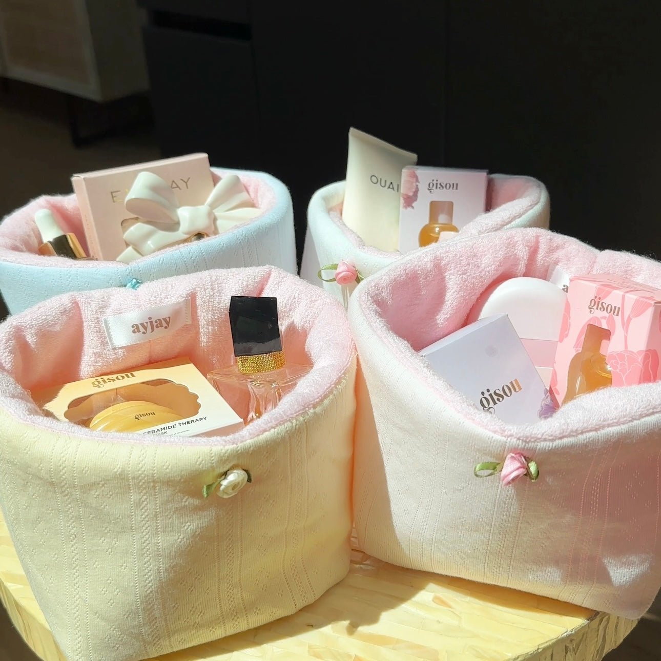 Light blue and pink fabric organizer baskets with stitched rims and small tie details