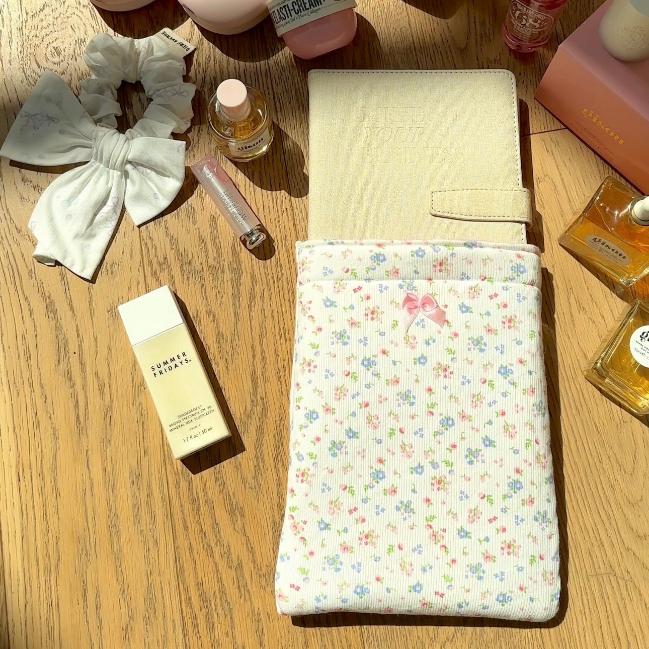 White fold-over Kindle book sleeve with multicolor floral fabric and front patch pocket