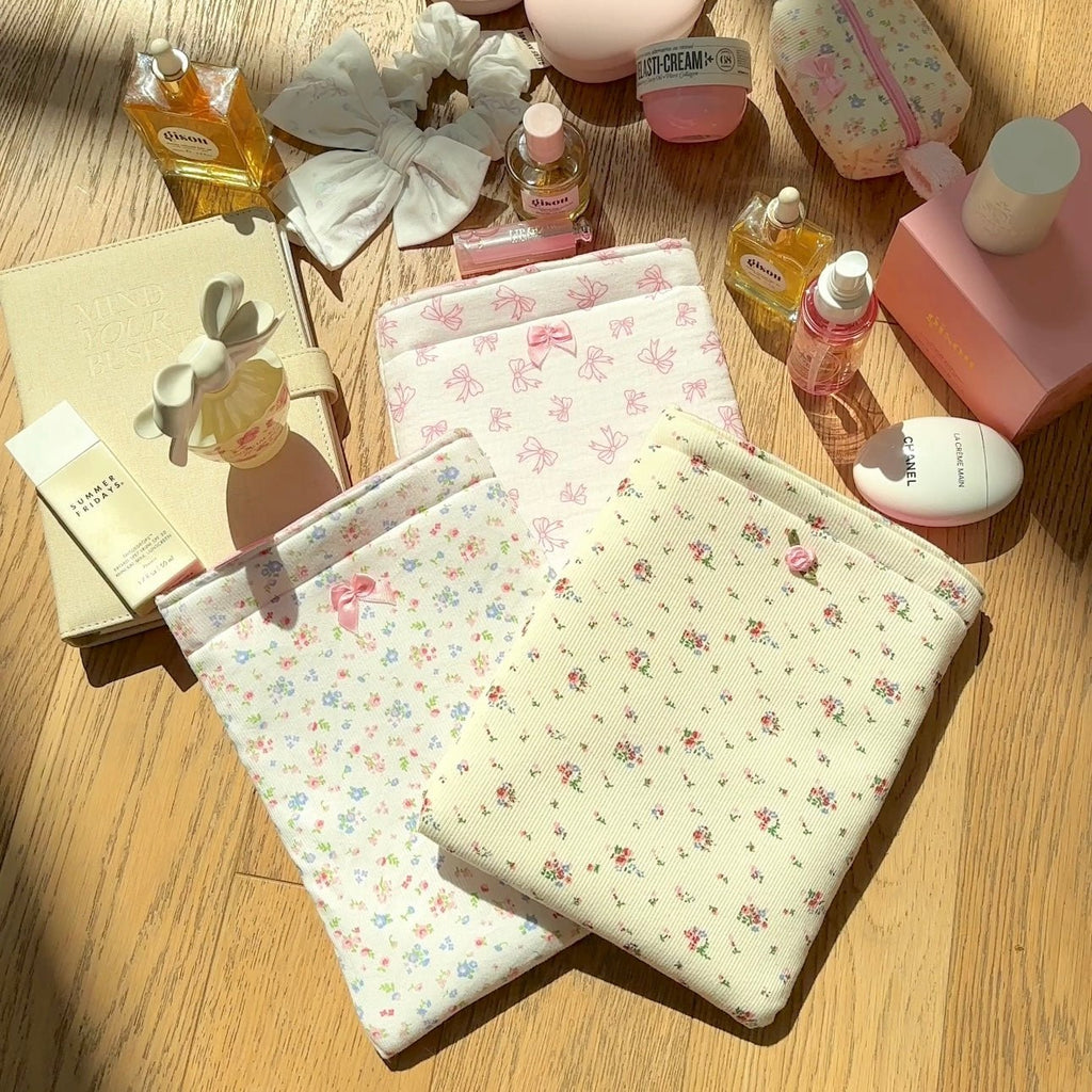 White Kindle book sleeve with pink bow floral print, fold-over top and stitched border