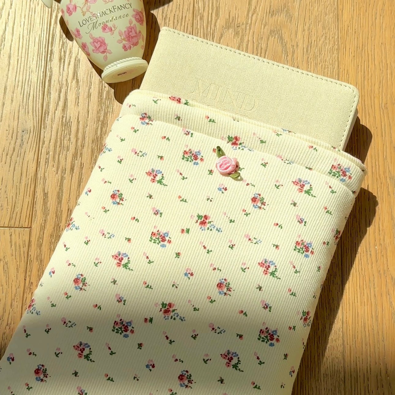 Ivory Kindle book sleeve with tiny floral dot print and pink rose button accent