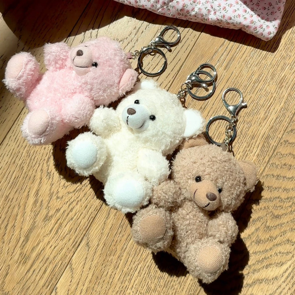 Pink, white, and tan teddy bear plush keychain charms with silver split rings