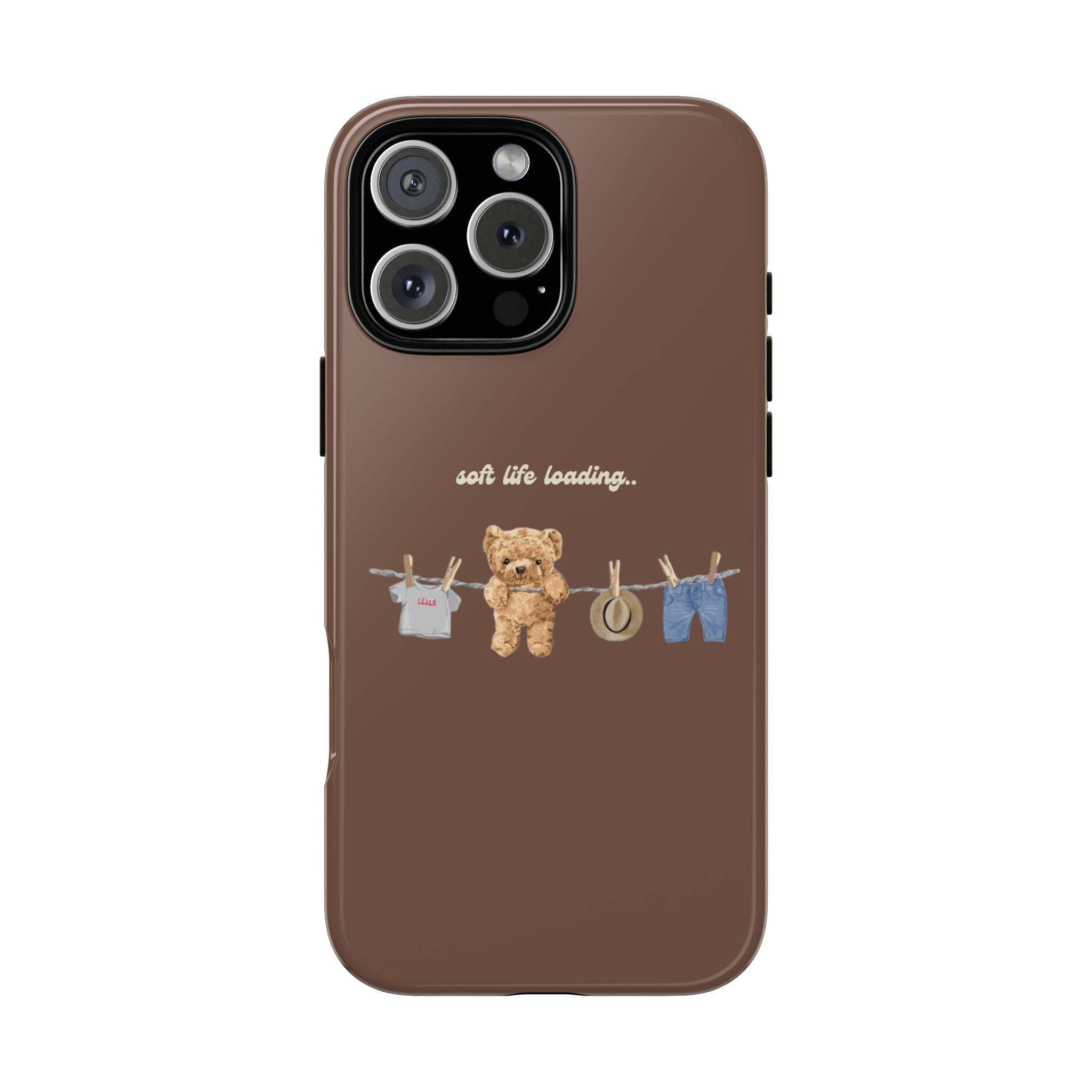 Brown phone case with teddy bear, clothesline clips, 'soft life loading' text
