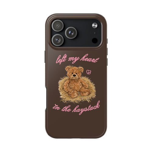 Brown phone case with teddy bear illustration and pink script, camera cutout visible