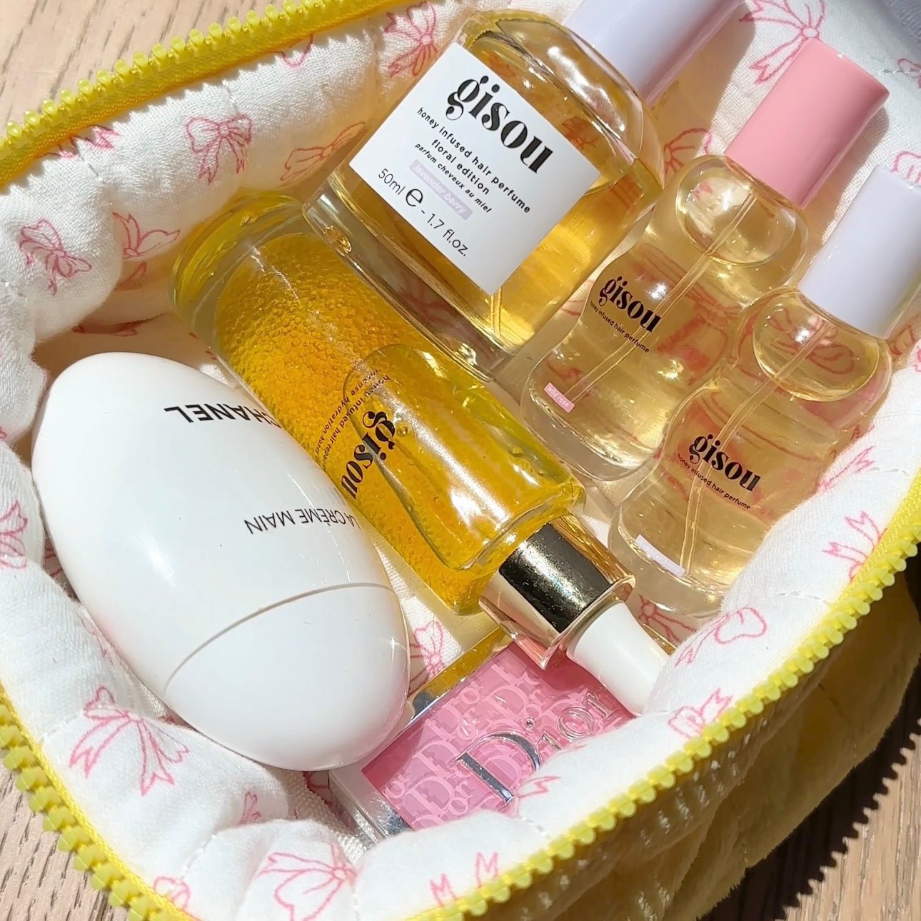 Inside yellow mini vanity bag with butterfly print lining and gold perfume bottles