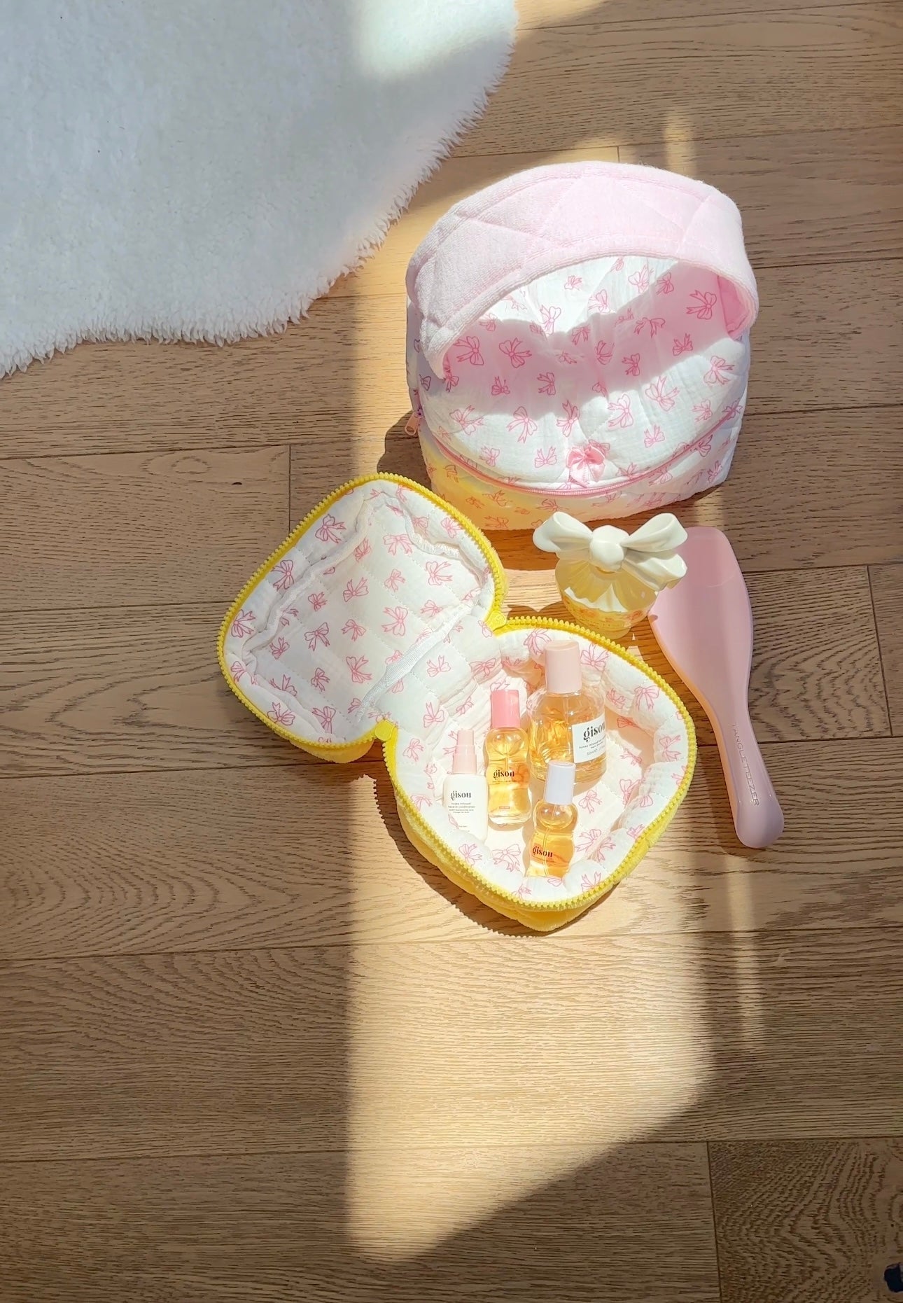 Yellow mini vanity bag with bow detail and butterfly print lining, open top