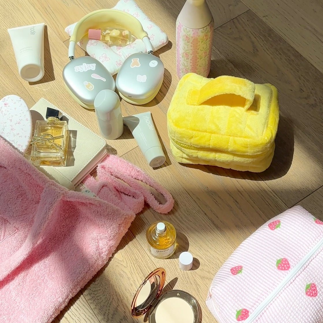 Yellow mini vanity bag open with yellow trim, holding perfume bottles inside butterfly print