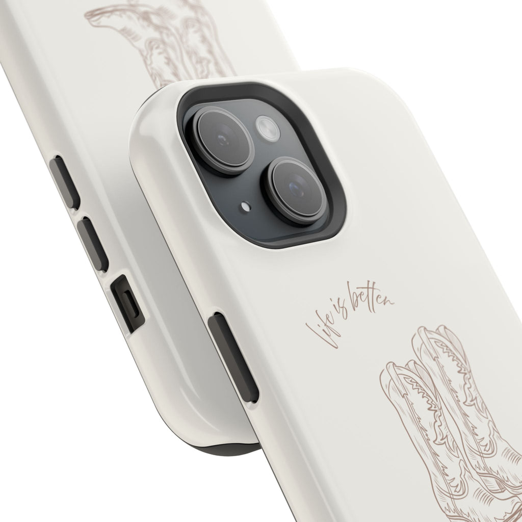 Angled white phone case with boots illustration, “life’s better” script, and camera cutout.