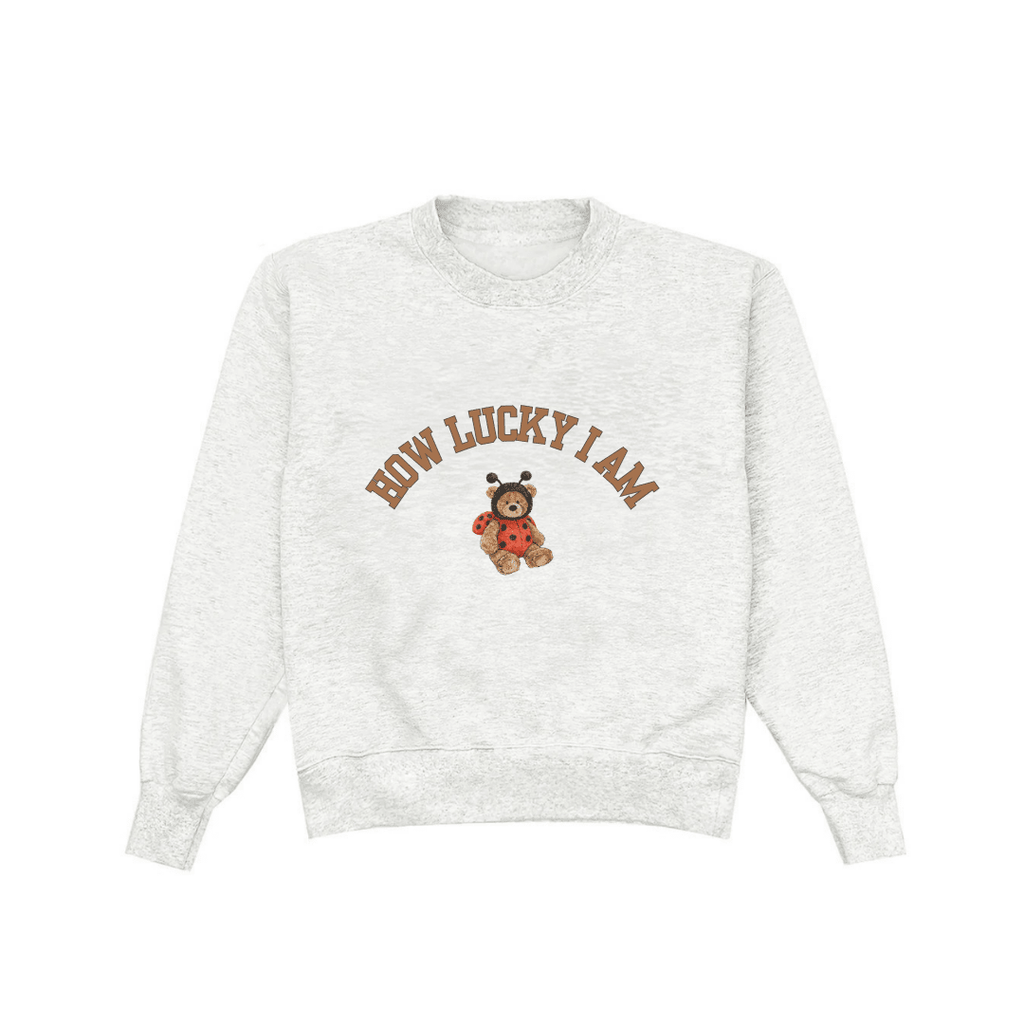 Light gray crewneck sweatshirt front view with bear-and-ladybug 'HOW LUCKY I AM' print