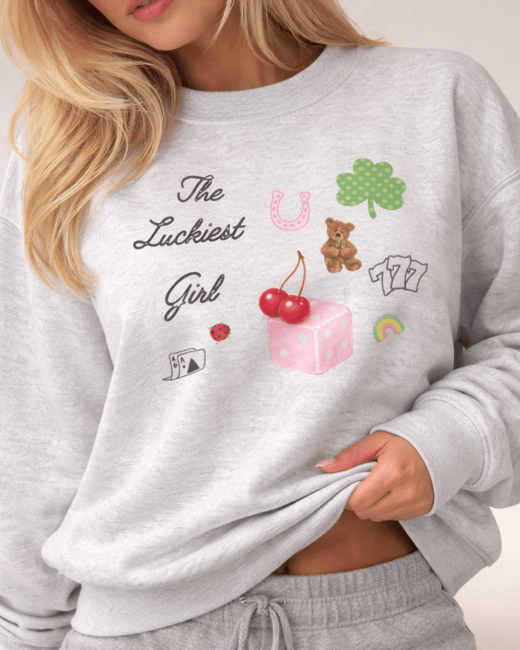 Light gray crewneck sweatshirt, graphic patchwork design on chest, long sleeves