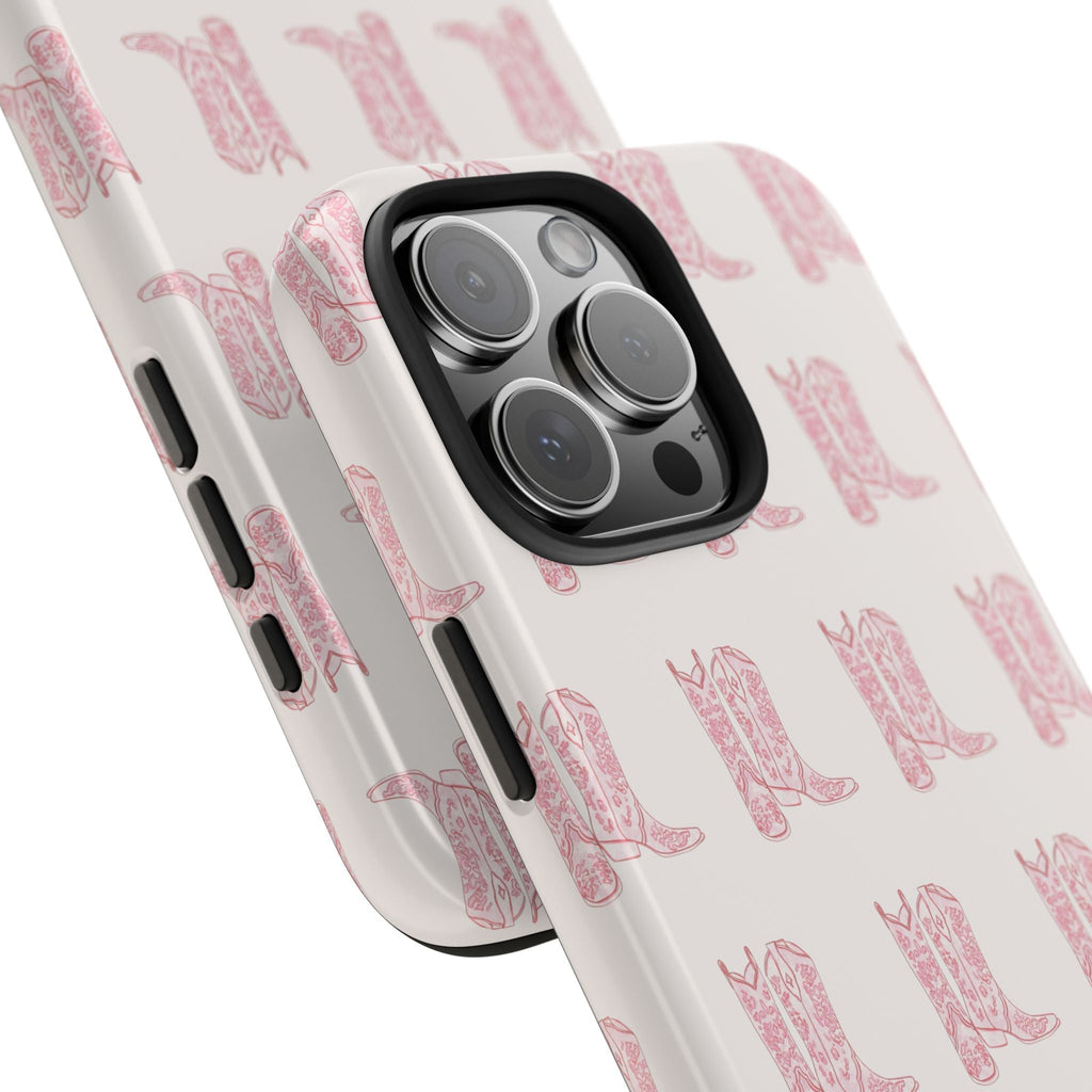 Light pink cowboy boots pattern phone case, angled view showing camera rings and buttons