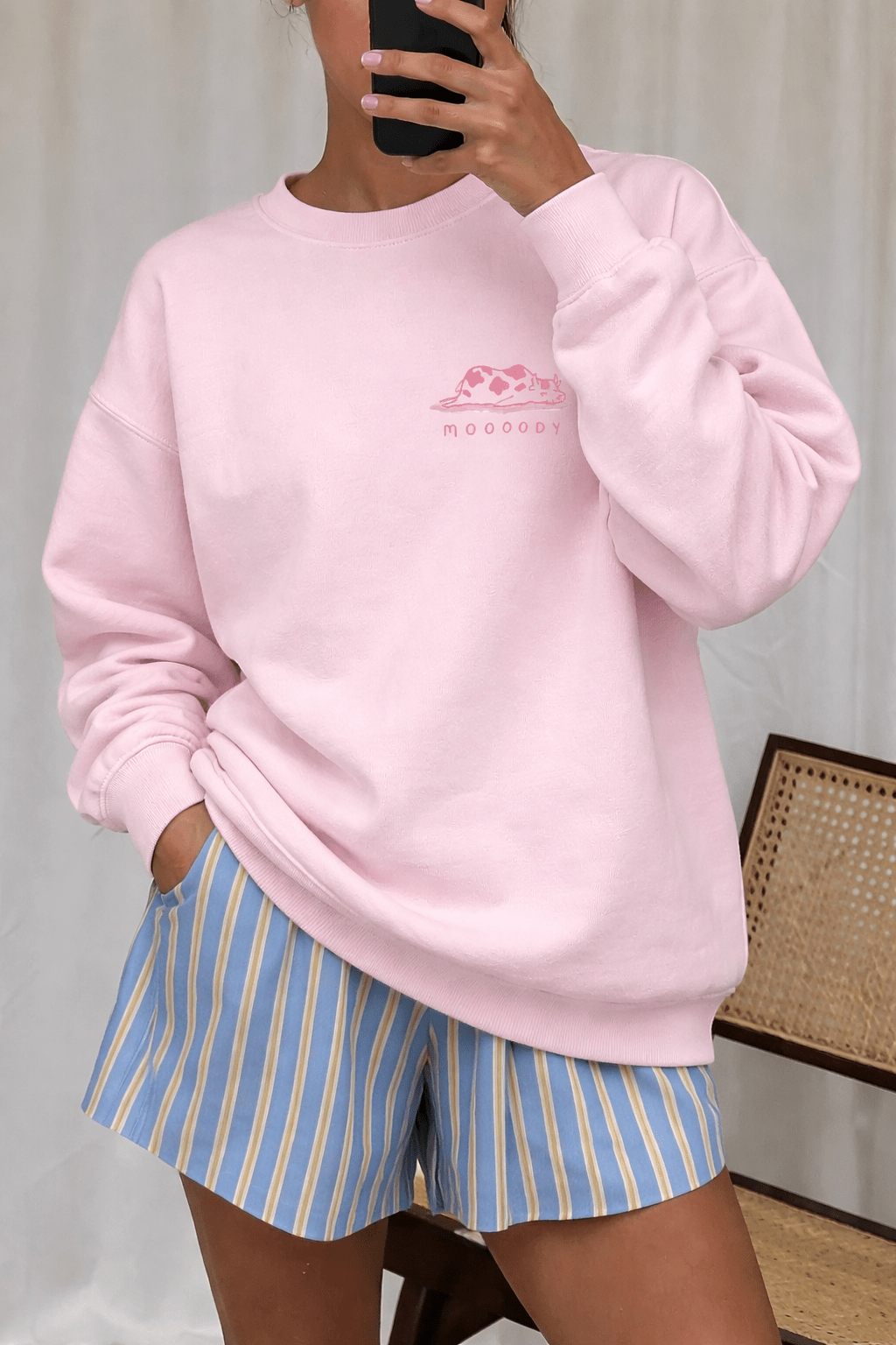 Light pink crewneck sweatshirt with pink cow graphic and long sleeves, relaxed fit