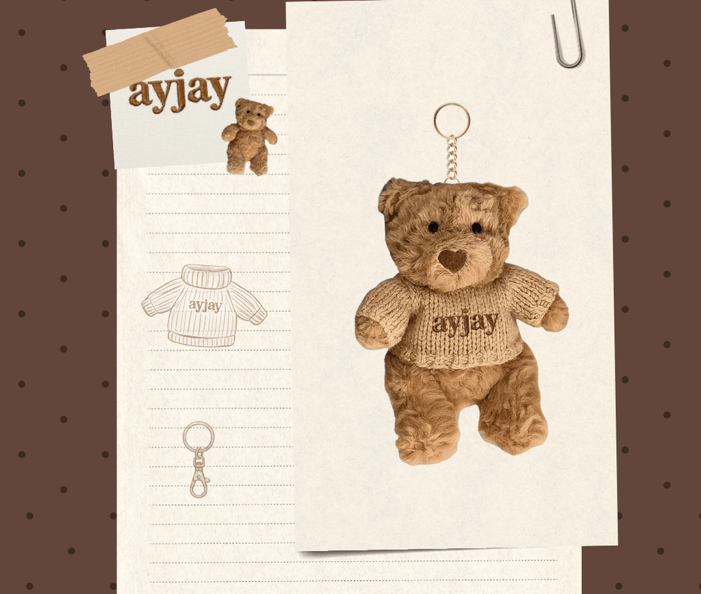 Tan teddy bear keychain in knit sweater with 'ayjay' text on hanging tag