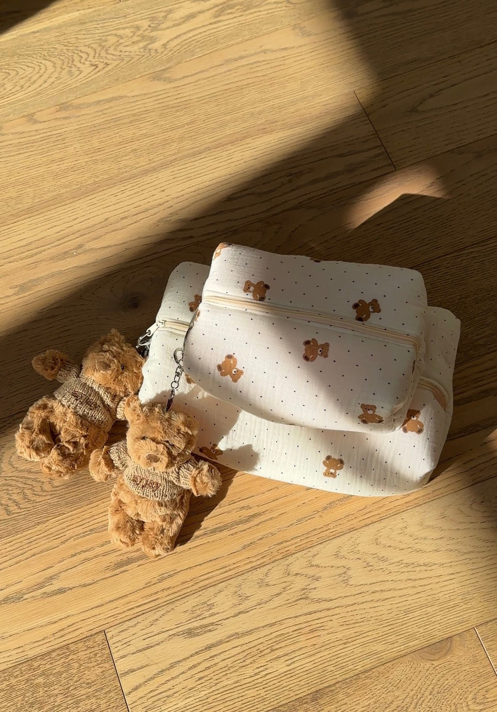 Cream teddy bear print cosmetic pouch with zipper, flat lay view