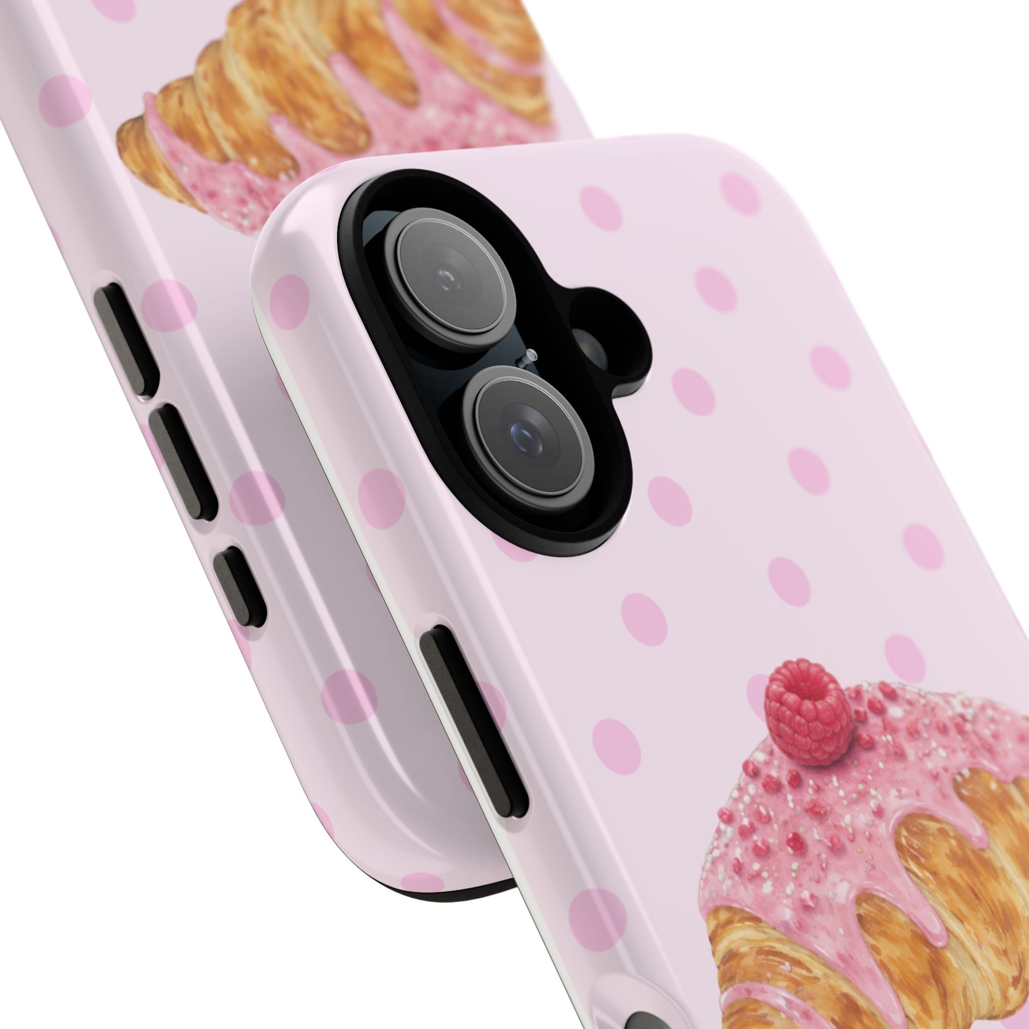 Close-up: pink dotted croissant phone case with raspberry topping by camera lenses