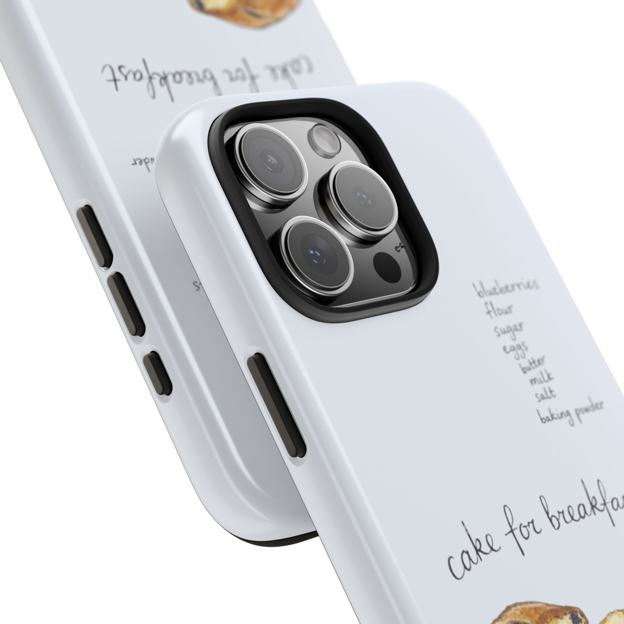 Close-up of white phone case edge and camera cutout with “cake for breakfast” design
